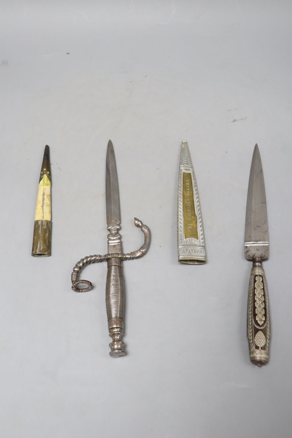 An Italian 19th century dagger stiletto, engraved silver mounts, horn grip, brass sheath sides with inscription Di Coltello Perira Chi